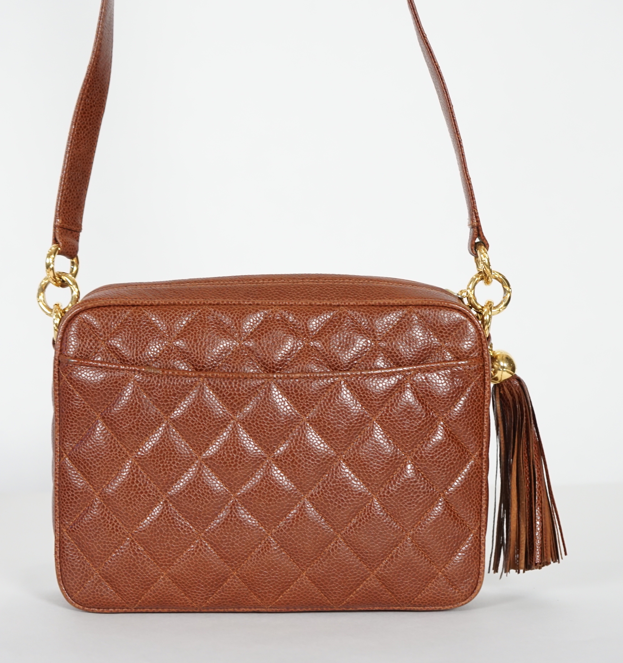 A Chanel vintage camera bag with tassel in brown quilted calf skin, width 23cm, height 27cm, depth 27cm